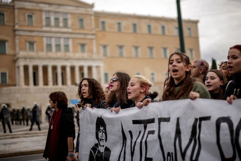 &copy; Reuters. Students shout slogans while holding a banner depicting 15-year-old student Alexandros Grigoropoulos, who was killed in 2008 by a police officer, during an anniversary rally outside the parliament building in Athens, Greece, December 6, 2022. REUTERS/Alki