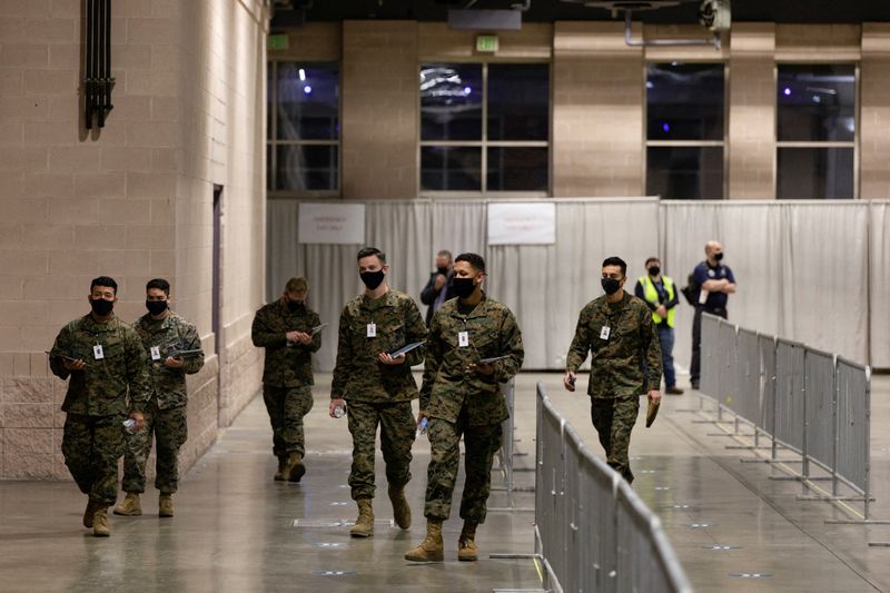 © Reuters. FILE PHOTO: Military personnel walk through at one of FEMA's Community Vaccination Center in Philadelphia, Pennsylvania, U.S., March 2, 2021.  REUTERS/Hannah Beier/File Photo