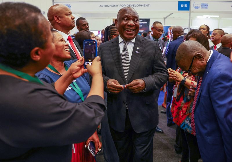 &copy; Reuters. South Africa's President Cyril Ramaphosa speaks with delegates ahead of his keynote address at the opening session of the World Science Forum in Cape Town where he is to make his first public appearance since the publication of a report that found he may 