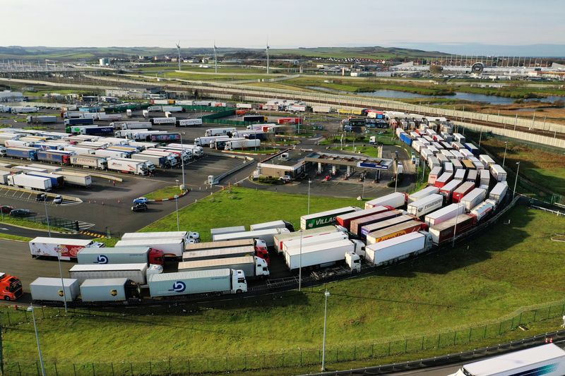© Reuters. Trucks queue to embark aboard the freight shuttle at Eurotunnel terminal in Coquelles near Calais, France, December 16, 2020. Picture taken with a drone. REUTERS/Pascal Rossignol/File Photo