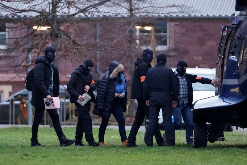 © Reuters. Police escort a person after 25 suspected members and supporters of a far-right group were detained during raids across Germany, in Karlsruhe, Germany December 7, 2022. REUTERS/Heiko Becker