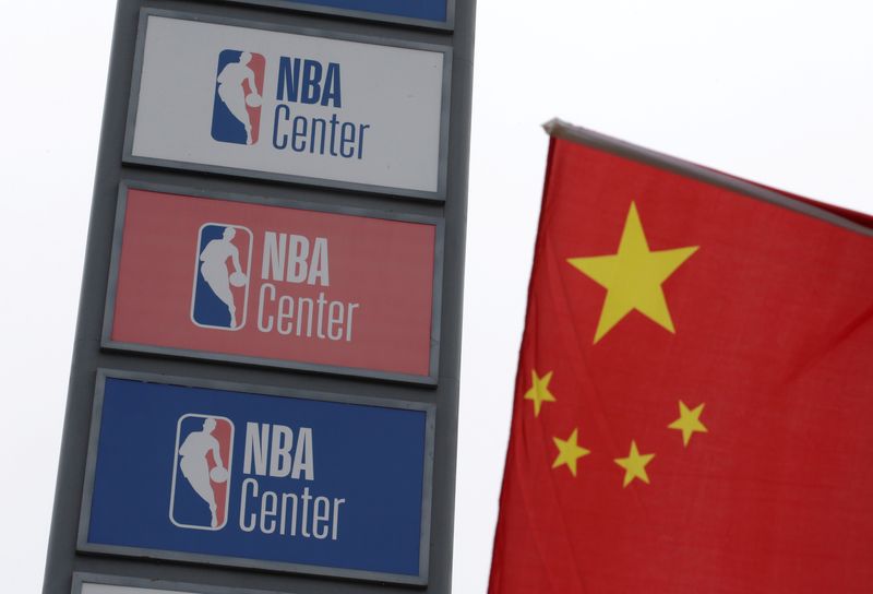 &copy; Reuters. FILE PHOTO: NBA logos are seen next to a Chinese national flag outside a NBA-themed lifestyle complex on the outskirts of Tianjin, China, October 10, 2019. REUTERS/Jason Lee/File Photo