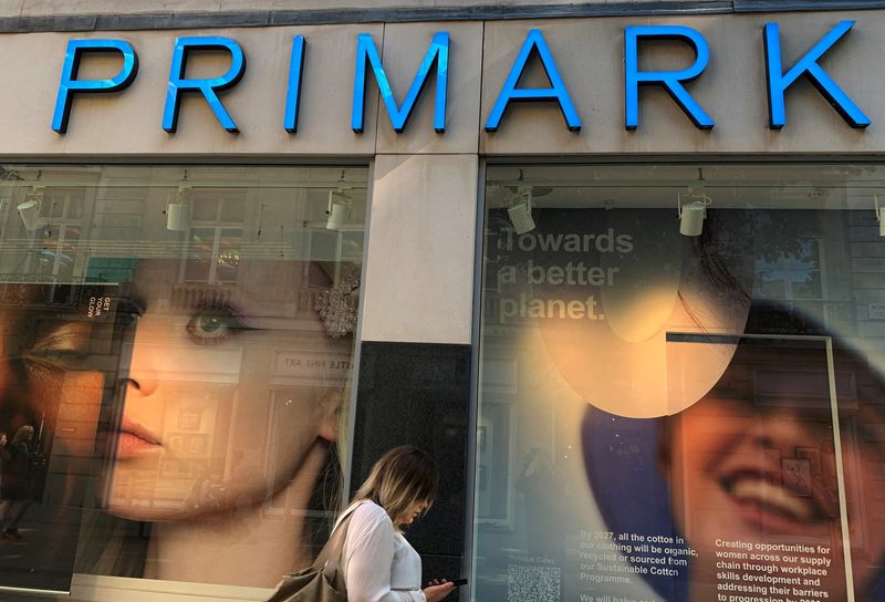 &copy; Reuters. FILE PHOTO: A woman walks past a window display at a Primark store in Liverpool, Britain, September 15, 2021. REUTERS/Phil Noble