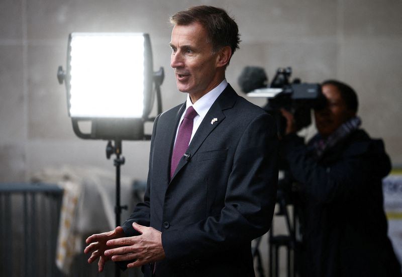 &copy; Reuters. FILE PHOTO: British Chancellor of the Exchequer Jeremy Hunt talks to a television crew outside the BBC headquarters in London, Britain November 18, 2022. REUTERS/Henry Nicholls/File Photo