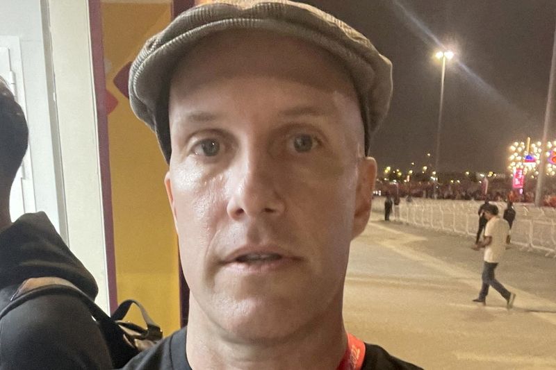 © Reuters. FILE PHOTO: Grant Wahl, who claimed that he was briefly detained when he tried to enter a World Cup stadium in Qatar while wearing a rainbow shirt in support of the LGBTQ community, is seen in a 