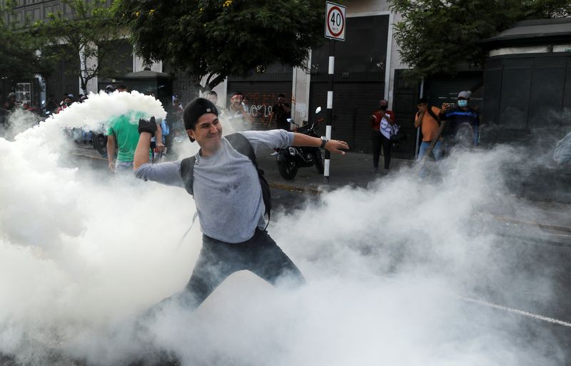 &copy; Reuters. A demonstrator prepares to throw back a tear gas canister during a protest demanding the dissolution of Congress and to hold democratic elections rather than recognize Dina Boluarte as Peru's President, after the ousting of Peruvian President Pedro Castil