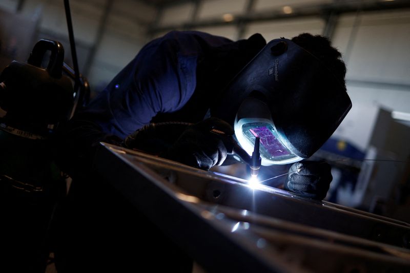 &copy; Reuters. FILE PHOTO: An employee works at the luxury boat-maker company 'Fratelli Canalicchio' who are facing growing difficulties as the price of steel has doubled over the last year crimping profit margins as inflation, looming recession and impossibly high ener