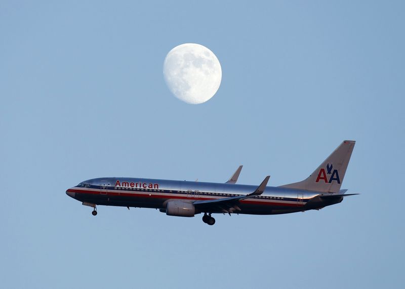 &copy; Reuters. FILE PHOTO: An American Airlines passenger jet glides in under the moon as it lands at LaGuardia airport in New YorkNew York, August 28, 2012. REUTERS/Eduardo Munoz 