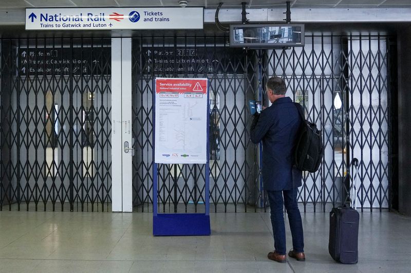 &copy; Reuters. A traveller stands in front of a closed gate, as rail workers strike over pay and terms, at Blackfriars station in London, Britain December 13, 2022. REUTERS/Maja Smiejkowska