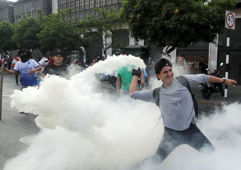 &copy; Reuters. Un manifestante se prepara para devolver un bote de gas lacrimógeno durante una protesta exigiendo la disolución del Congreso y celebrar elecciones democráticas en lugar de reconocer a Dina Boluarte como presidenta de Perú, tras la destitución del pr