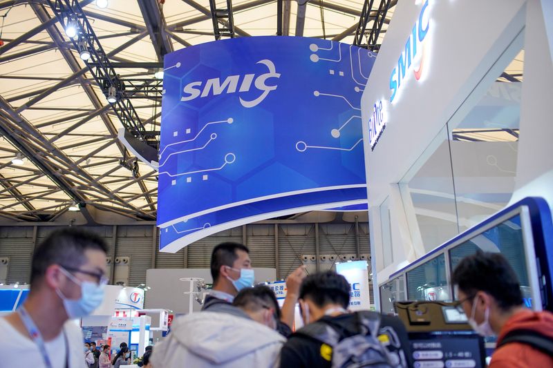 &copy; Reuters. FILE PHOTO: People visit a booth of Semiconductor Manufacturing International Corporation (SMIC), at China International Semiconductor Expo (IC China 2020) in Shanghai, China October 14, 2020. REUTERS/Aly Song