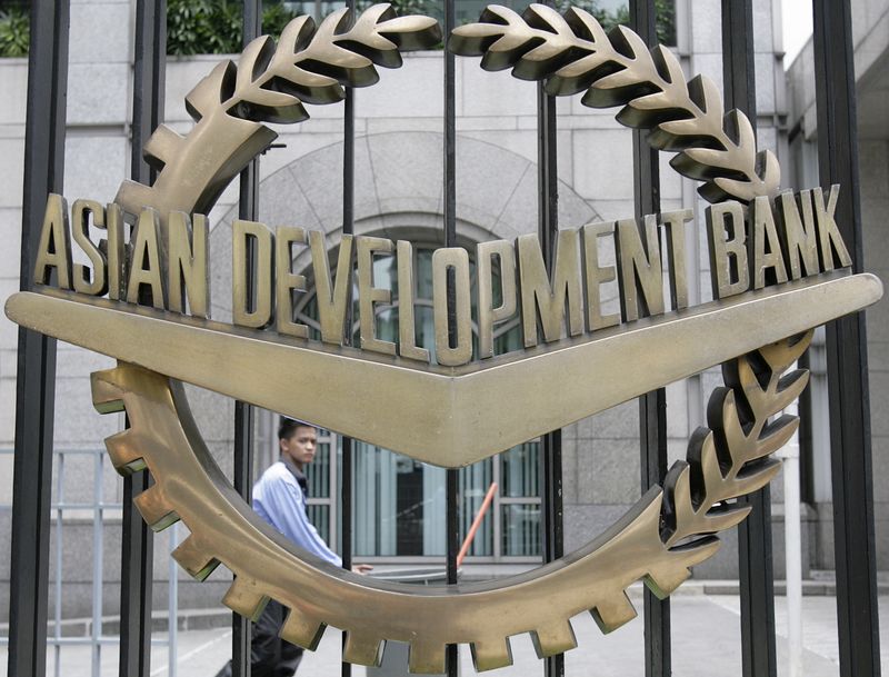 &copy; Reuters. FILE PHOTO: A worker walks past inside the Asian Development Bank (ADB) headquarters in Manila June 17, 2009.  REUTERS/Cheryl Ravelo 