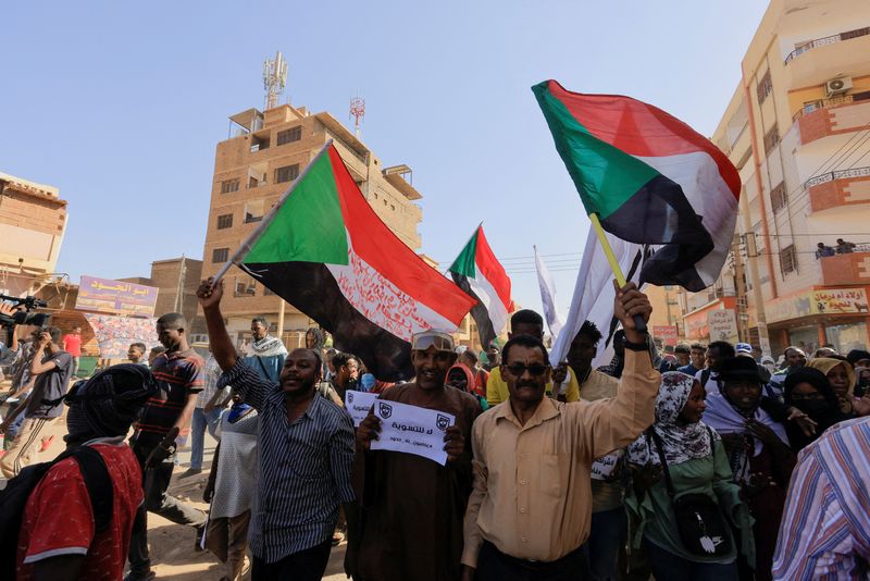 &copy; Reuters. FILE PHOTO: Protesters march during a rally against a signed framework deal between political parties and the military that provides for a two-year civilian-led transition towards elections and would end a standoff triggered by a coup in October 2021, in 