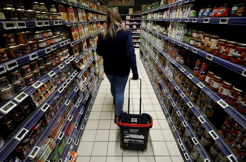 &copy; Reuters. FILE PHOTO: A woman walks with a shopping trolley as she shops in an Utile supermarket in La Verrie, France, December 9, 2022. REUTERS/Stephane Mahe