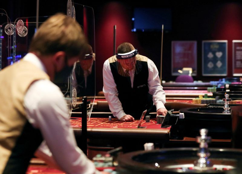 &copy; Reuters. FILE PHOTO: Staff members work before the reopening of Grosvenor Casino on St James' Blvd on August 1, after lockdown due to the outbreak of the coronavirus disease (COVID-19), in Newcastle upon Tyne, Britain July 31, 2020. REUTERS/Lee Smith/File Photo