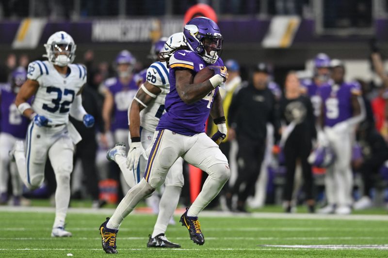 &copy; Reuters. Dec 17, 2022; Minneapolis, Minnesota, USA; Minnesota Vikings running back Dalvin Cook (4) scores on a touchdown reception as Indianapolis Colts safety Rodney McLeod (26) and safety Julian Blackmon (32) pursue late during the fourth quarter at U.S. Bank St