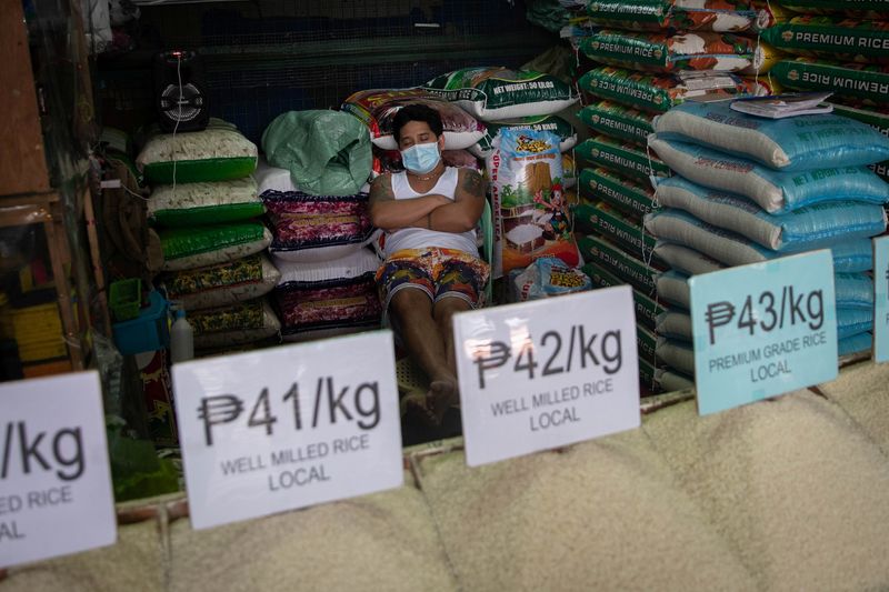 &copy; Reuters. FILE PHOTO: A vendor wearing a face mask for protection against the coronavirus disease (COVID-19) sleeps in a stall selling rice at a public market in Quezon City, Metro Manila, Philippines, January 5, 2021. REUTERS/Eloisa Lopez