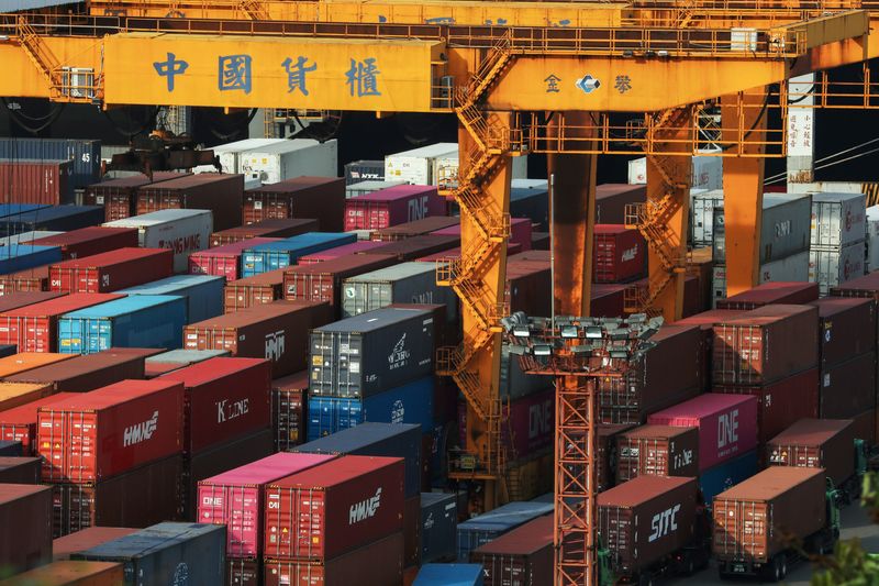 &copy; Reuters. FILE PHOTO: Trucks wait to be loaded on with containers at a port in Keelung, Taiwan, June 10, 2020. REUTERS/Ann Wang