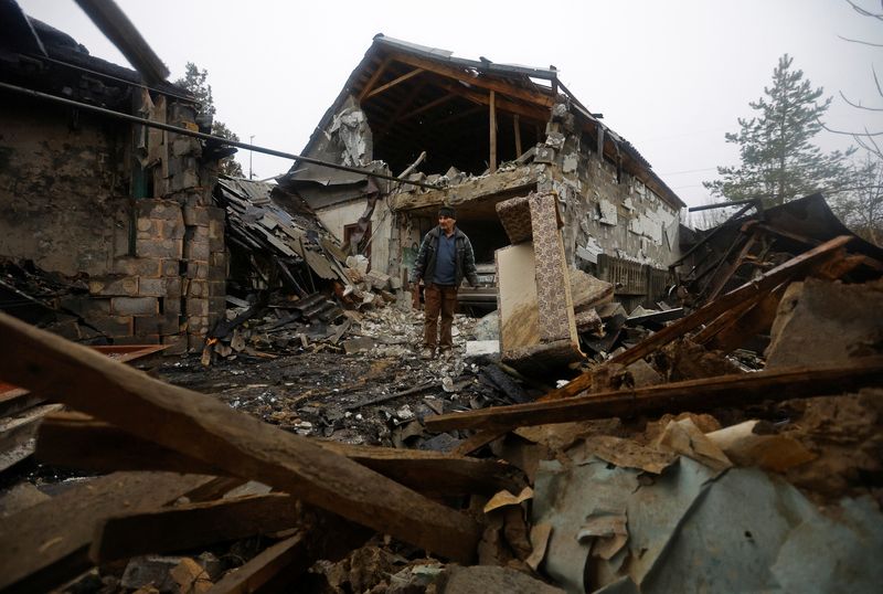 &copy; Reuters. Local resident Amiram stands next to his friend's house destroyed by recent shelling in the course of Russia-Ukraine conflict in Donetsk, Russian-controlled Ukraine, December 17, 2022. REUTERS/Alexander Ermochenko