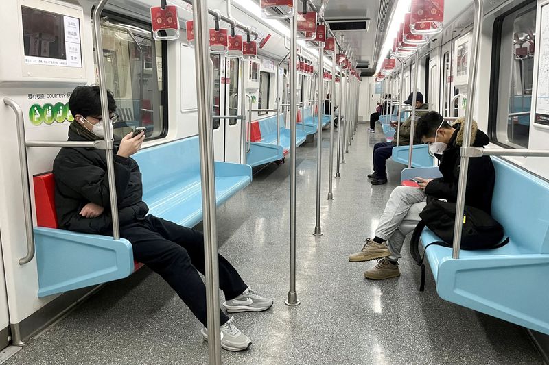 &copy; Reuters. Commuters wear protective masks while they ride a subway train as coronavirus disease (COVID-19) outbreaks continue in Shanghai, China, December 20, 2022. REUTERS/Casey Hall