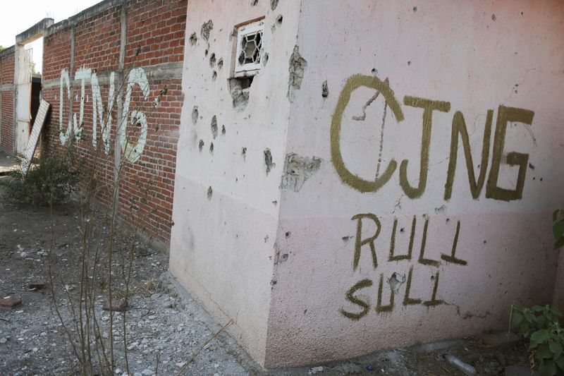 &copy; Reuters. FILE PHOTO: A bullet-riddled facade with the acronym of the Jalisco New Generation Cartel (CJNG) is pictured in El Aguaje after the visit of Vatican's ambassador to Mexico Franco Coppola to the area and to the municipality of Aguililla, an area where the 