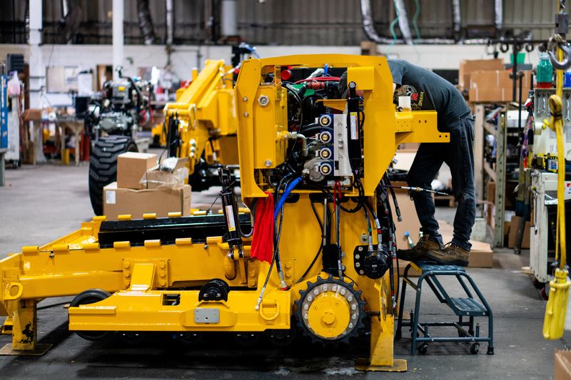 &copy; Reuters. William Vasquez assembles a paving machine at the Calder Brothers factory in Taylors, South Carolina, U.S., in this handout picture taken July 18, 2021. Brandon Granger/Calder Brothers Corporation/Handout via REUTERS