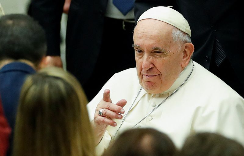 &copy; Reuters. El papa Francisco saluda a la gente mientras llega para dirigir una audiencia especial para entregar un mensaje de Navidad a los trabajadores del Vaticano en el Aula Pablo VI en el Vaticano. 22 de diciembre, 2022. REUTERS/Remo Casilli