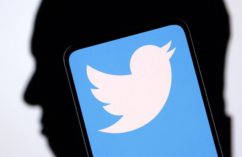 &copy; Reuters. FILE PHOTO: Twitter logo and Elon Musk silhouette are seen in this illustration taken, December 19, 2022. REUTERS/Dado Ruvic/Illustration