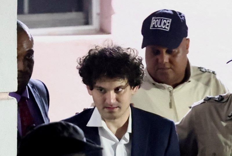 &copy; Reuters. FILE PHOTO: Sam Bankman-Fried, who founded and led FTX until a liquidity crunch forced the cryptocurrency exchange to declare bankruptcy, is escorted out of the Magistrate Court building after his arrest in Nassau, Bahamas December 13, 2022.  REUTERS/Dant