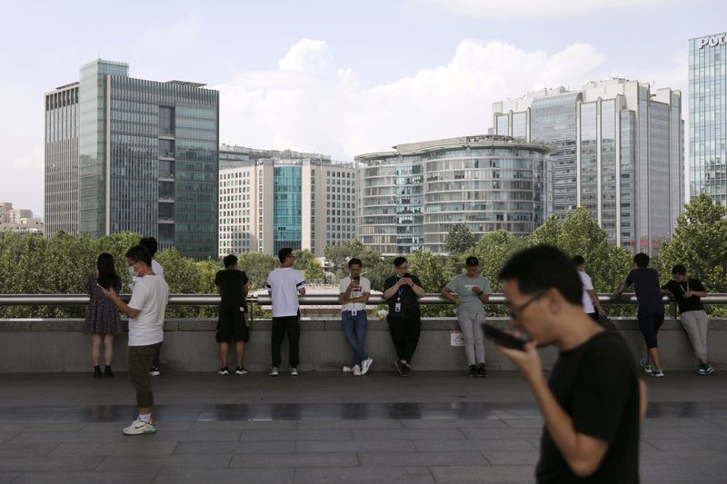 &copy; Reuters. FILE PHOTO: People are seen at Beijing's tech hub Zhongguancun, China August 23, 2021. REUTERS/Tingshu Wang