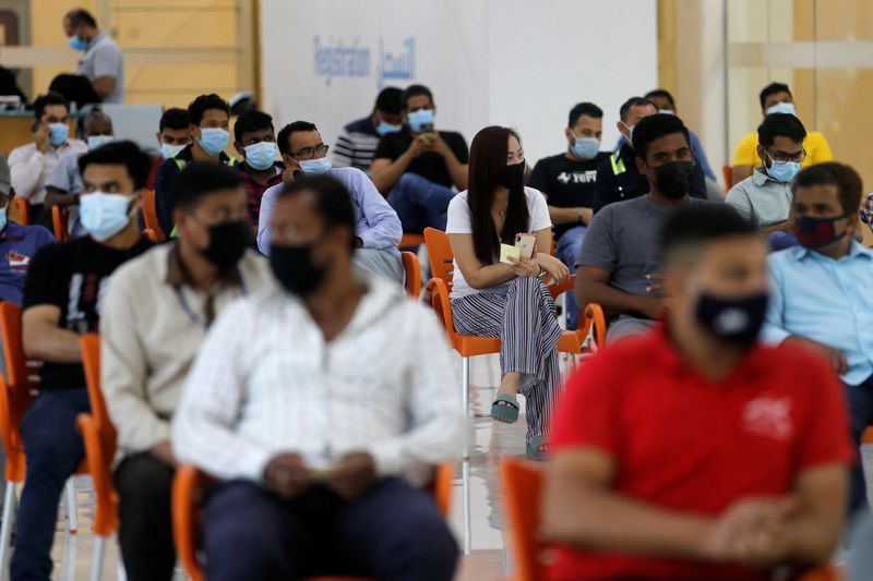 &copy; Reuters. FILE PHOTO: People wait in Sitra Mall to get vaccination against the coronavirus disease (COVID-19), in Sitra, Bahrain, March 23, 2021. Picture taken March 23, 2021. REUTERS/Hamad I Mohammed