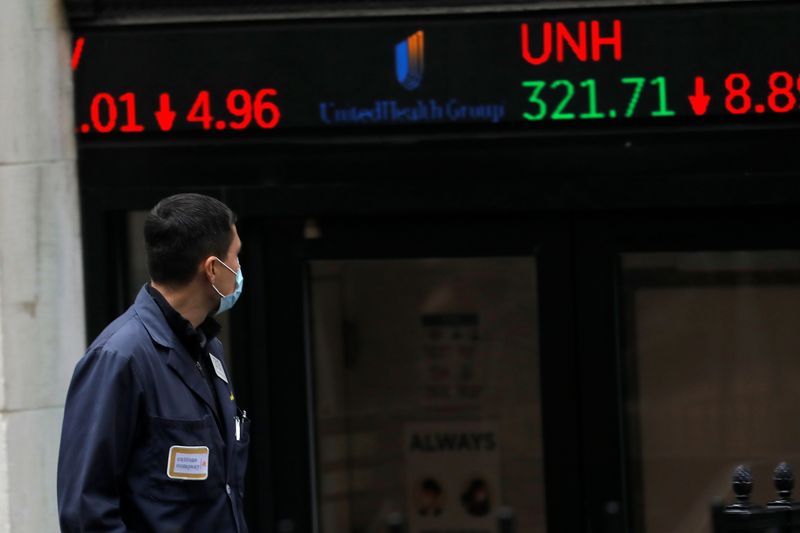 &copy; Reuters. FILE PHOTO: A trader walks past a digital stock price display outside the New York Stock Exchange in Manhattan in New York City, New York, U.S., October 26, 2020. REUTERS/Mike Segar