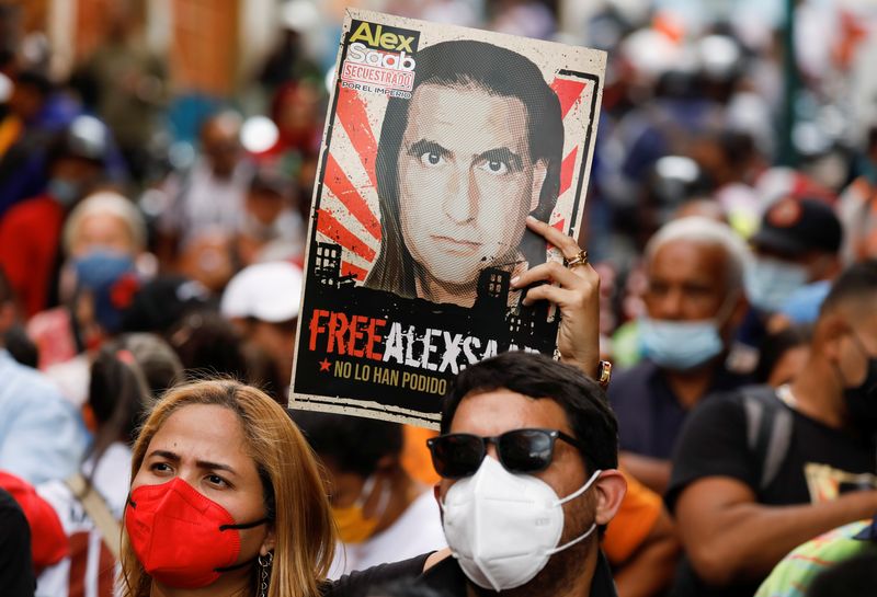&copy; Reuters. FOTO DE ARCHIVO: Una mujer sostiene un cartel con la imagen de Alex Saab, un empresario colombiano con vínculos venezolanos que fue extraditado a Estados Unidos acusado de lavado de dinero, durante una manifestación que pide su liberación, en Caracas, 