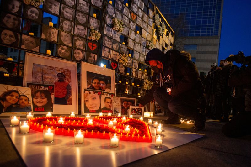 &copy; Reuters. FILE PHOTO: Mourners attend an outdoor vigil for the victims of Ukrainian passenger jet flight PS752 which was shot down two years ago over Iran, in Toronto, Ontario, Canada January 8, 2022. REUTERS/Carlos Osorio