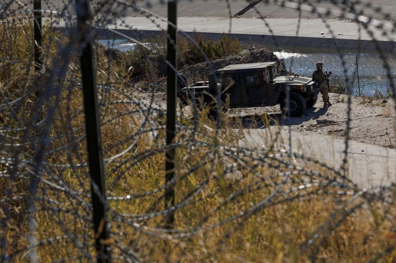 &copy; Reuters. FILE PHOTO: A member of the Texas National Guard stands by a vehicle along the Rio Bravo river, the border between Mexico and the U.S., as seen from El Paso, Texas, U.S., December 22, 2022. REUTERS/Carlos Barria