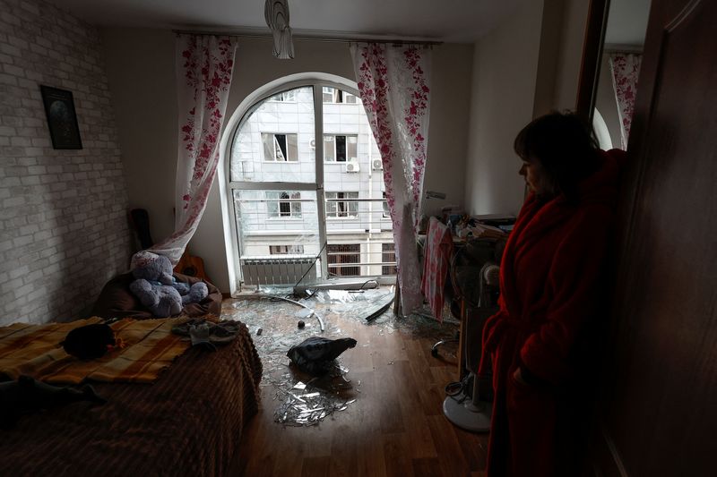 © Reuters. سيدة تقف داخل غرفة في شقتها التي تضررت جراء غارة جوية روسية بطائرة مسيرة على كييف يوم الجمعة. تصوير: فالنتين أوجيرنكو - رويترز.