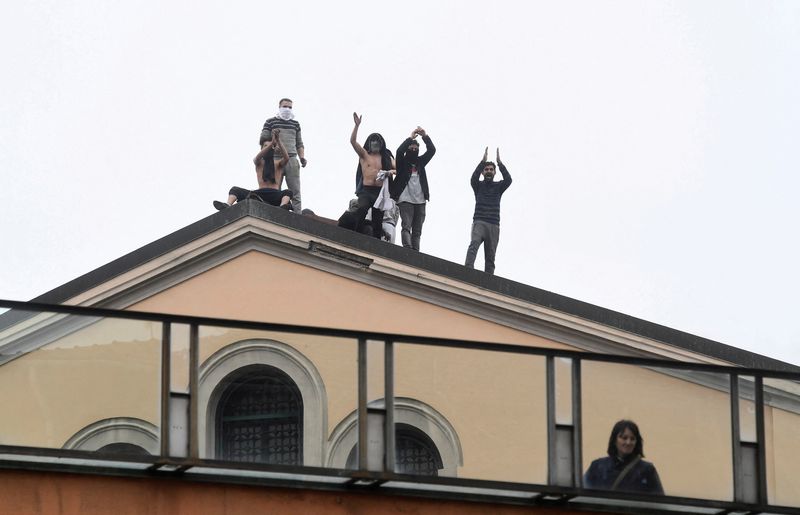 &copy; Reuters. FILE PHOTO: Inmates are seen on the roof of the San Vittore Prison during a revolt after family visits were suspended due to fears over coronavirus contagion, in Milan, Italy March 9, 2020. REUTERS/Flavio Lo Scalzo/File Photo