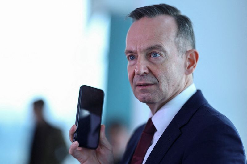 &copy; Reuters. FILE PHOTO: German Transport Minister Volker Wissing holds a mobile phone at the attend the weekly cabinet meeting in Berlin, Germany November 30, 2022. REUTERS/Lisi Niesner/File Photo