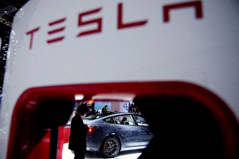 © Reuters. FILE PHOTO: A Tesla electric vehicle is seen through a charging point displayed during a media day for the Auto Shanghai show in Shanghai, China April 20, 2021. REUTERS/Aly Song