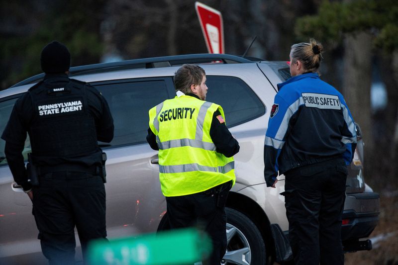 &copy; Reuters. FILE PHOTO: Security workers and Pennsylvania State Agents stand guard at the gate of the private Indian Mountain Lake community after Pennsylvania State Police took into custody Bryan Kohberger, a 28-year-old suspect wanted in the killings of four Univer