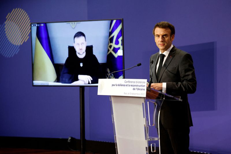 &copy; Reuters. FILE PHOTO: Ukrainian President Volodymyr Zelensky listens via video link as French President Emmanuel Macron delivers a speech during the French-Ukrainian conference for resilience and reconstruction at the Ministry of Economy in Paris, France December 1