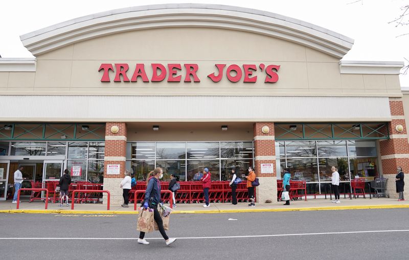 &copy; Reuters. FILE PHOTO: A shopper wearing a protective face mask passes near a self-distancing queue outside Trader Joe's, as they limited the amount of shoppers allowed in the store to help prevent the spread of coronavirus disease (COVID-19), in Bailey's Crossroads