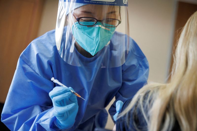 &copy; Reuters. Una enfermera vacuna a una mujer alemana mientras la embajada alemana comienza su despliegue de vacunas BioNTech COVID-19 para expatriados alemanes en un hospital de la Familia Unida de Pekín en Pekín, China, 5 de enero de 2023. REUTERS/Thomas Peter