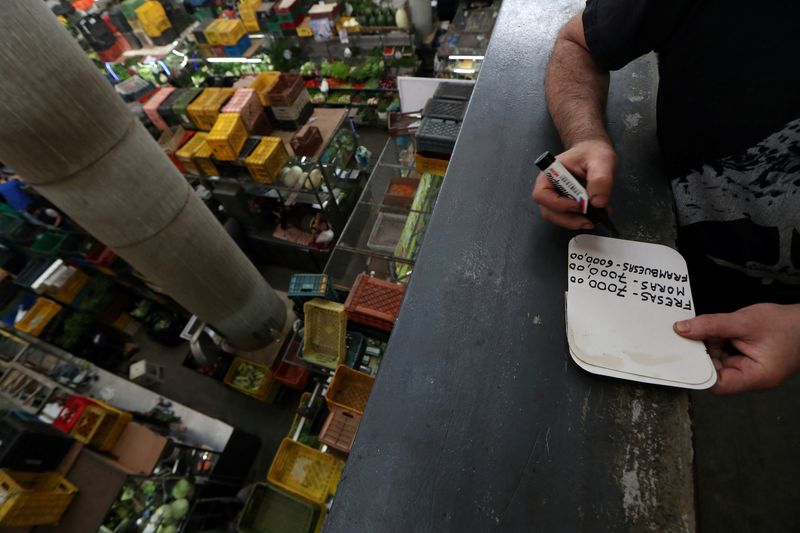 &copy; Reuters. A local makes a price list at a commercial center in Caracas, Venezuela March 14, 2019. REUTERS/Ivan Alvarado/File Photo