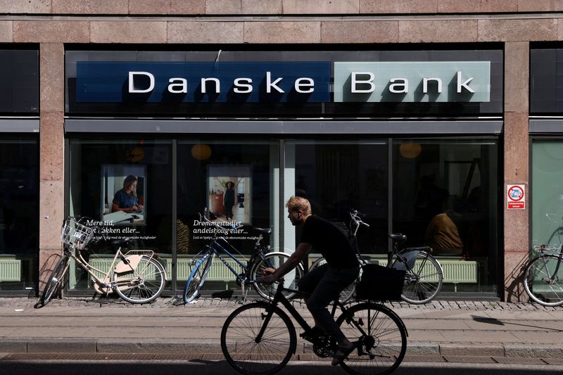 &copy; Reuters. FILE PHOTO: A person rides a bicycle past a Danske Bank branch in Copenhagen, Denmark, July 29, 2022. REUTERS/Andrew Kelly/File Photo
