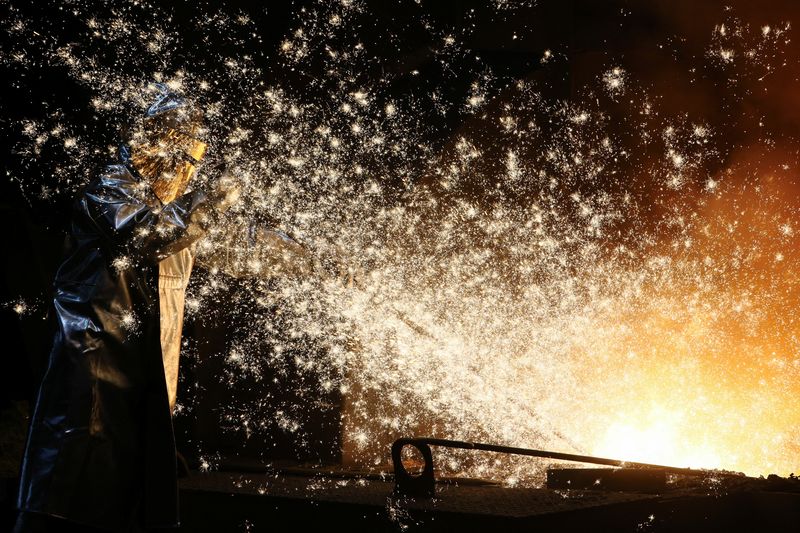 &copy; Reuters. FILE PHOTO: A steel worker of ThyssenKrupp stands amid sparks of raw iron coming from a blast furnace at a ThyssenKrupp steel factory in Duisburg, western Germany, November 14, 2022. REUTERS/Wolfgang Rattay