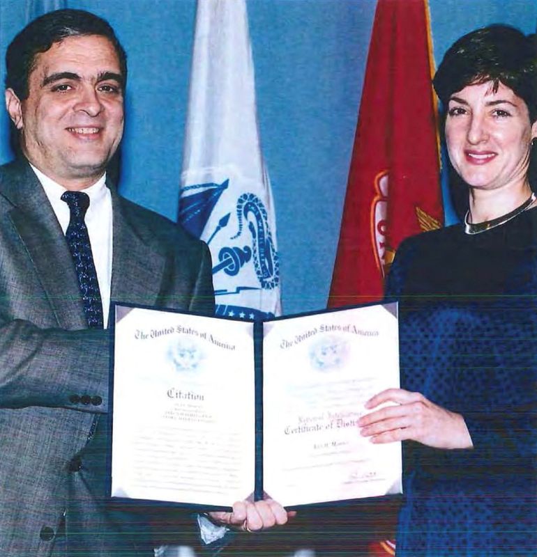 &copy; Reuters. FILE PHOTO: An undated handout image from a U.S. Department of Defense report dating back to 2005 shows Ana Belen Montes receiving a national intelligence certificate of distinction from George Tenet, who served as Director of Central Intelligence (DCI) f
