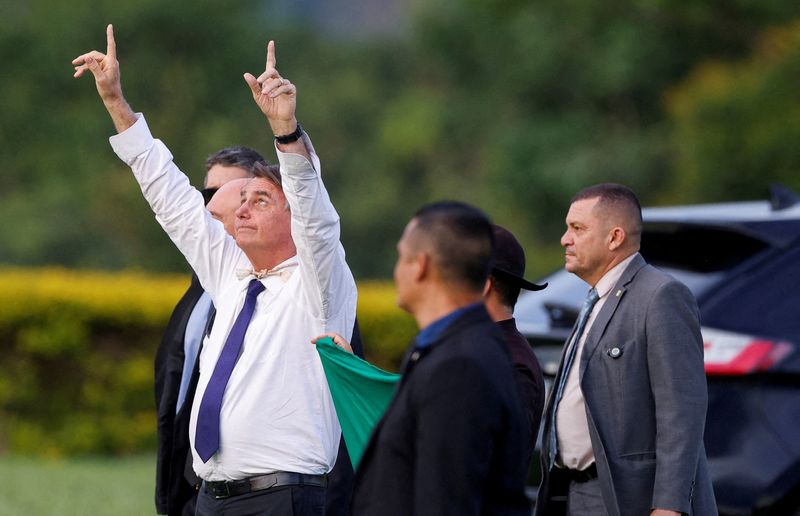 © Reuters. FILE PHOTO: Brazil's President Jair Bolsonaro gestures, as he meets supporters at the Alvorada Palace, in Brasilia, Brazil, December 12, 2022. REUTERS/Adriano Machado