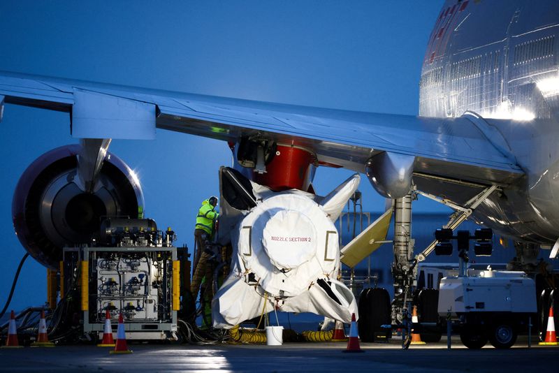 &copy; Reuters. FILE PHOTO: Technicians work on Virgin Orbit's LauncherOne rocket, attached to the wing of Cosmic Girl, a Boeing 747-400 aircraft, ahead of UK's First launch, at Spaceport Cornwall at Newquay Airport in Newquay, Britain, January 8, 2023. REUTERS/Henry Nic