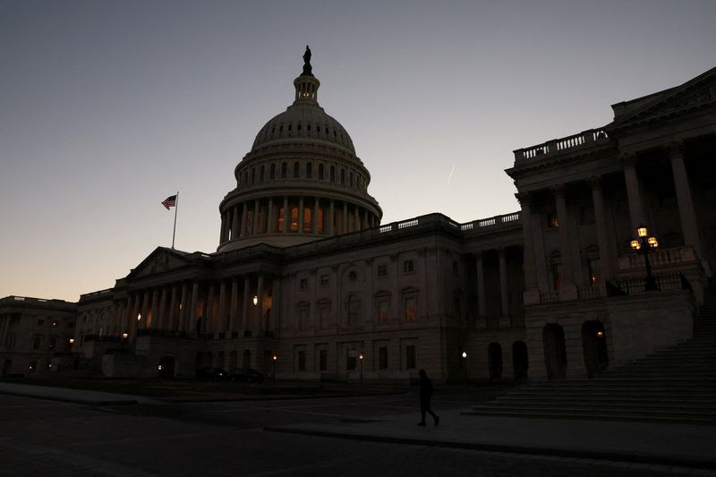 &copy; Reuters. FILE PHOTO: A person walks past the U.S. Capitol building at sunset as the Republican-controlled House of Representatives reconvenes on Capitol Hill in Washington, U.S., January 9, 2023. REUTERS/Leah Millis/File Photo